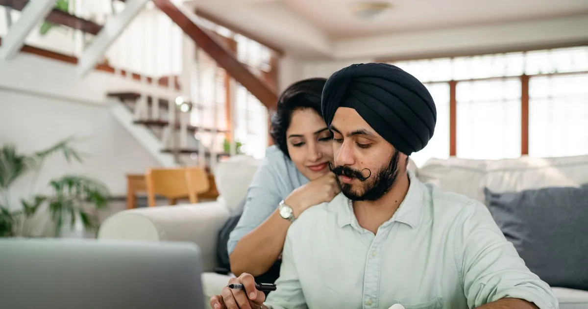 Couple at a laptop at home comparing terms on personal loans Scarborough lenders offer from $500 to $10000